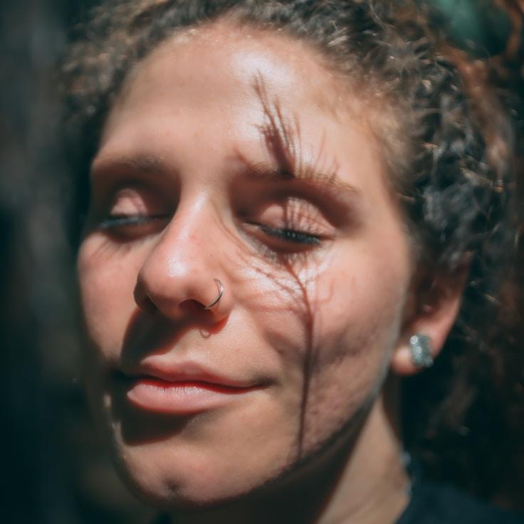 Avery Chen, Lead Design Curator at Golden Pine Grove, reviewing corporate floral arrangements